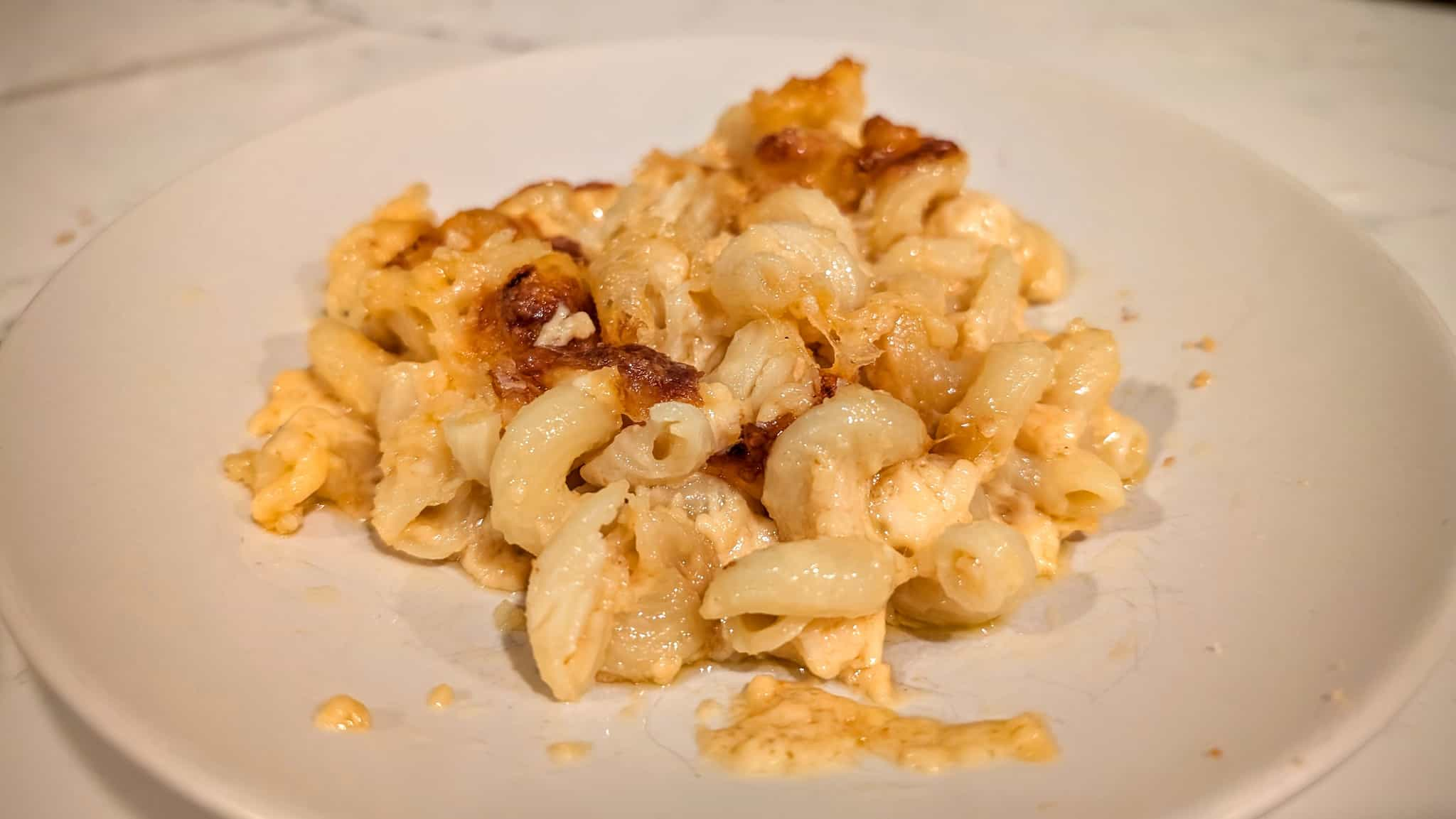 Plate of twisty pasta and cheese.